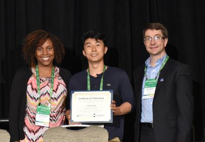 Tony Jin of McGill University pictured with poster judges (Photo Credit: Arthur Lemmon)